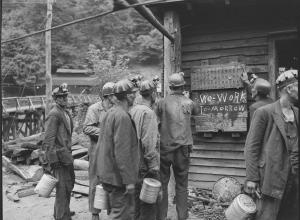 Miners bring in their checks and see the sign that there is no Saturday work. P V & K Coal Company, Clover Gap Mine, Lejunior, Harlan County, Kentucky.