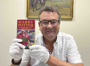 Auctioneer Richard Winterton with the Harry Potter book