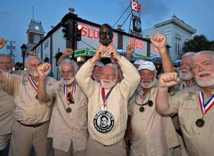 On his tenth attempt, David 'Bat' Masterson celebrates his 2024 victory with past winners of the Hemingway Look-Alike Contest outside Sloppy Joe's Bar in Key West.