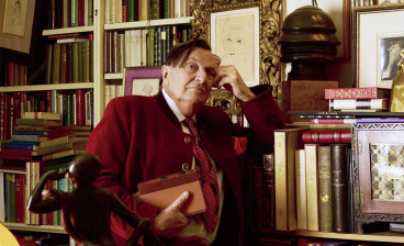 Barry Humphries in his library