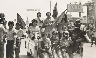 Journalists and protesters riding in the back of a pickup truck while covering a Chicano Movement protest ca. 1968-1975.