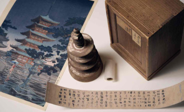 Hyakumantō Darani with wooden pagoda, storage box and facsimile text alongside a colour woodblock print of Horyuji Temple in Nara, Japan, where this particular darani was stored. Photo: Eugene Hyland. 