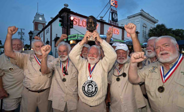 On his tenth attempt, David 'Bat' Masterson celebrates his 2024 victory with past winners of the Hemingway Look-Alike Contest outside Sloppy Joe's Bar in Key West.