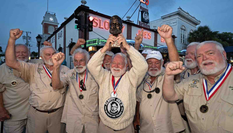 On his tenth attempt, David 'Bat' Masterson celebrates his 2024 victory with past winners of the Hemingway Look-Alike Contest outside Sloppy Joe's Bar in Key West.