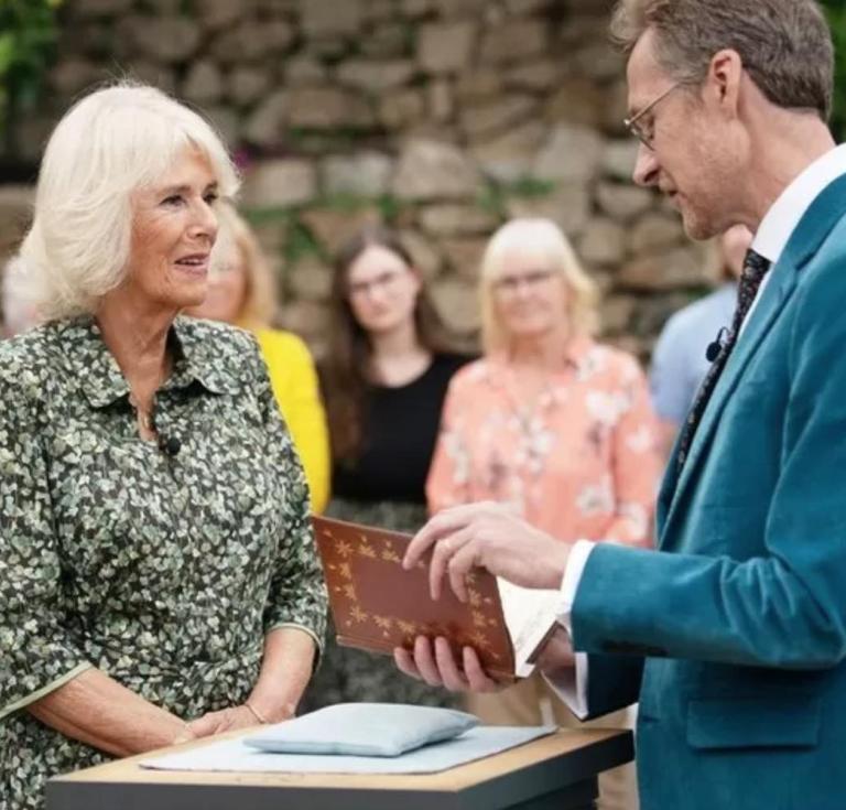 camilla on antiques roadshow with a book